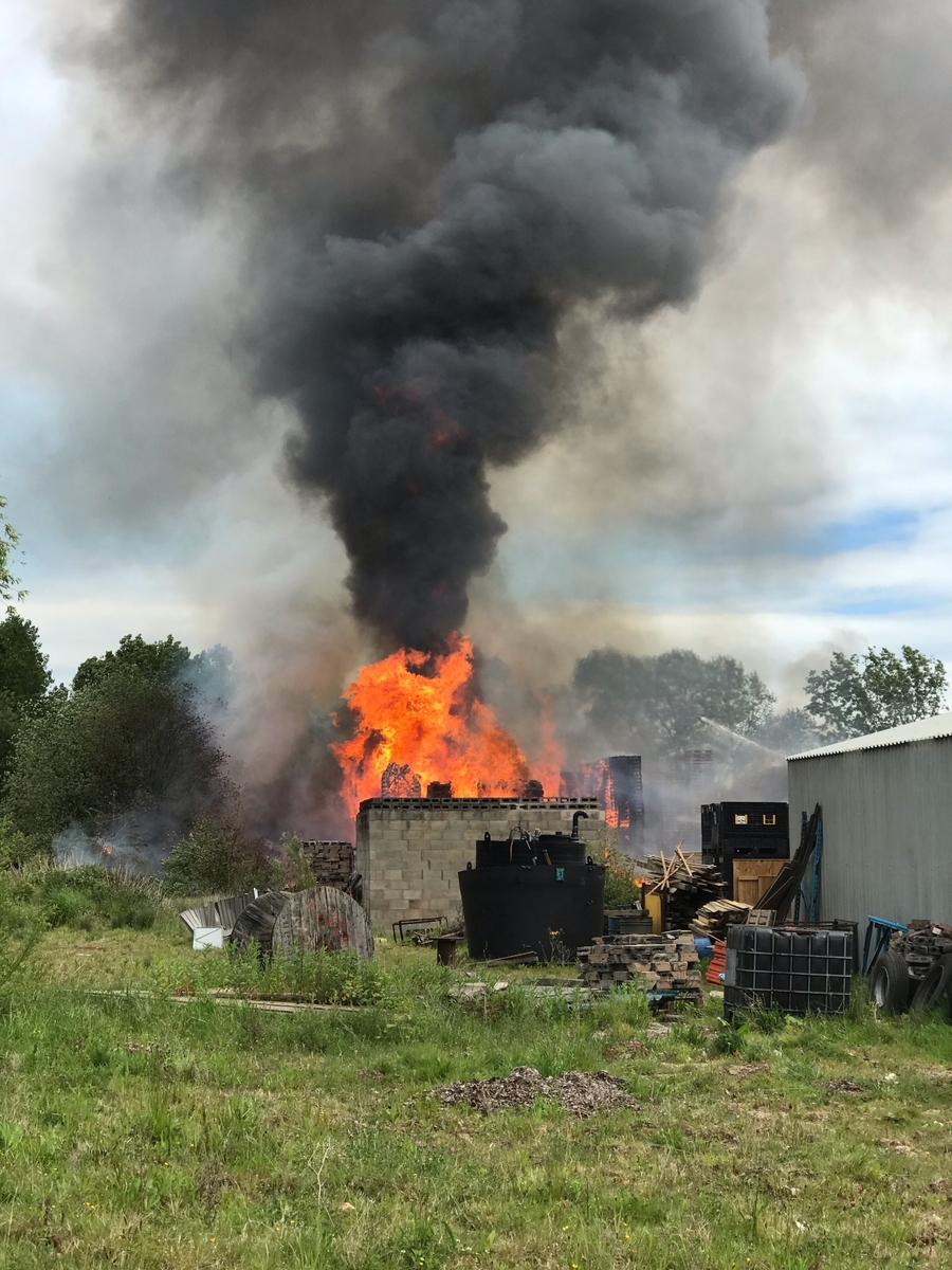 Image of a fire breaking out around outbuildings